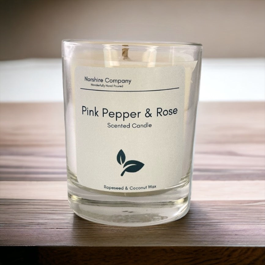 Pink Pepper & Rose Votive Candle on a wooden background